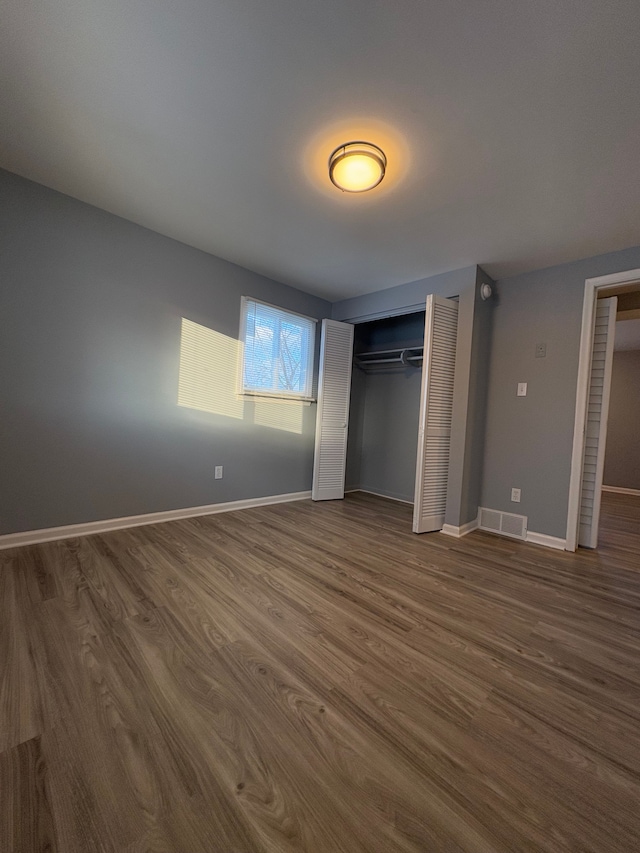 unfurnished bedroom featuring dark wood-type flooring