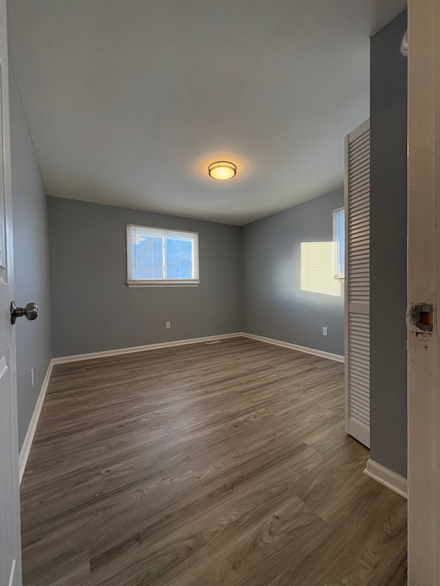 unfurnished room featuring dark hardwood / wood-style flooring