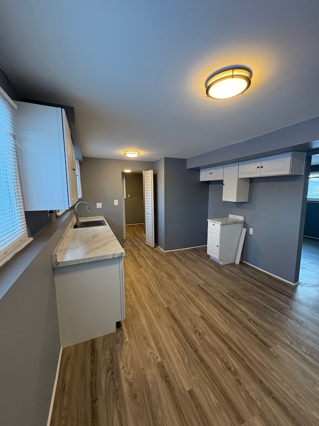 kitchen with white cabinets, sink, and dark wood-type flooring