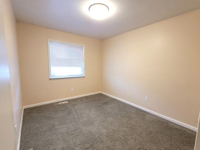 unfurnished room featuring carpet