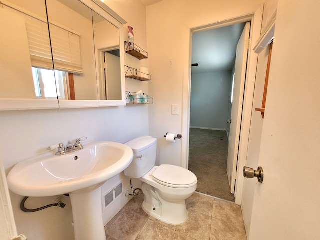 bathroom featuring tile patterned floors and toilet