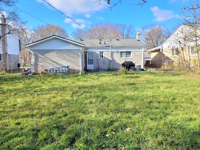 back of house with a lawn