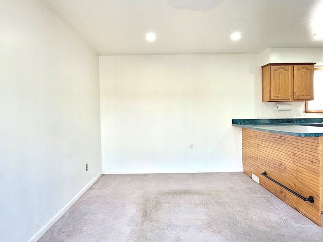 kitchen featuring light colored carpet