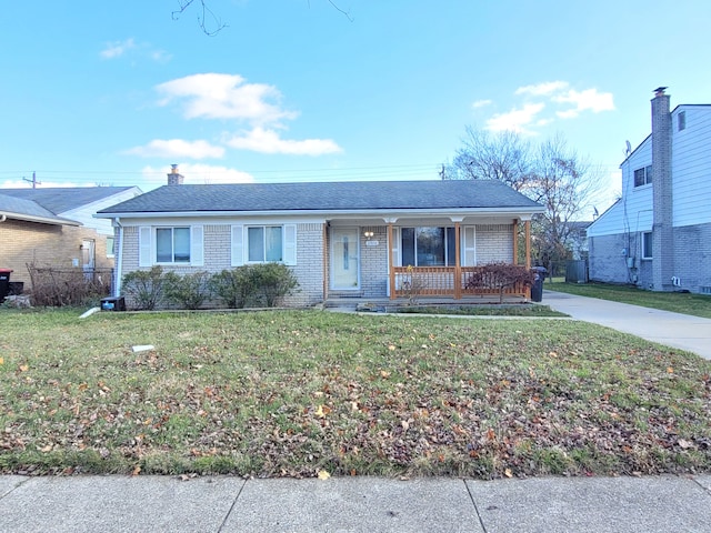 ranch-style home with covered porch and a front yard