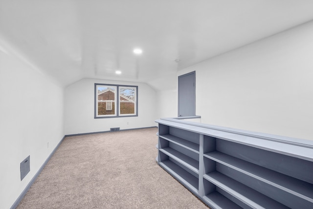 additional living space featuring carpet and lofted ceiling