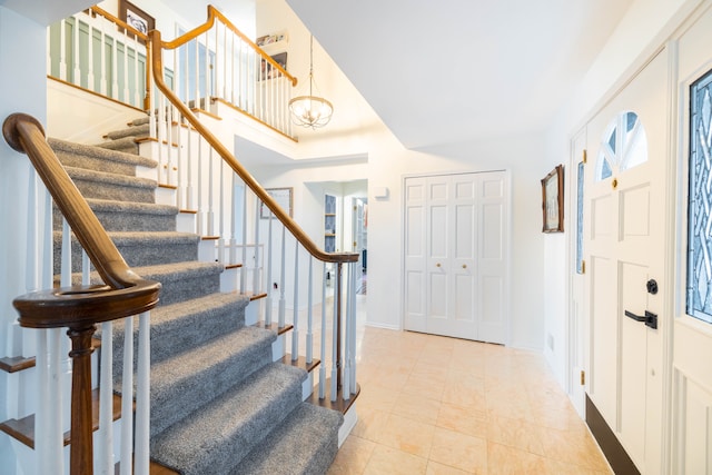 tiled foyer featuring a chandelier