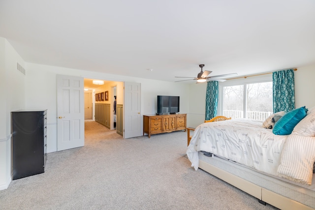 bedroom with light carpet and ceiling fan