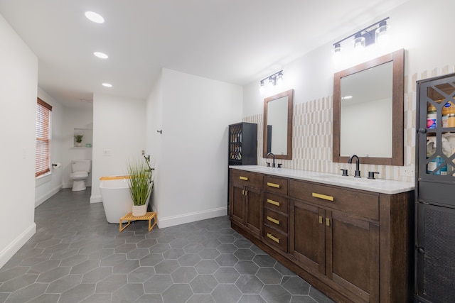 bathroom featuring tile patterned floors, vanity, and toilet