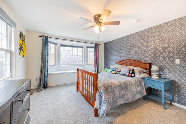 carpeted bedroom with multiple windows and ceiling fan