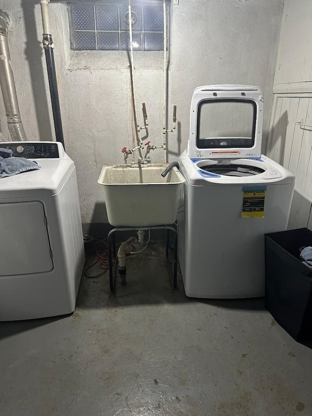 washroom with separate washer and dryer and sink