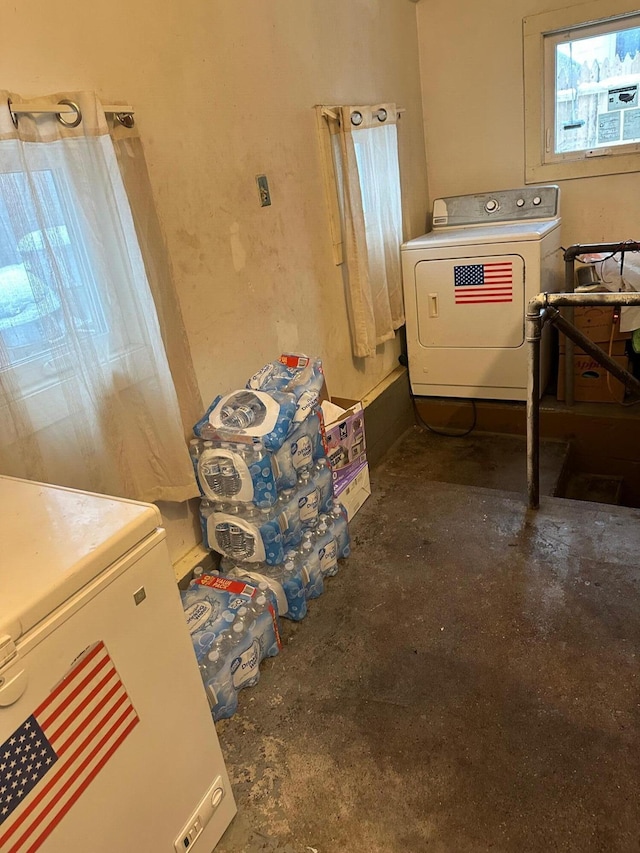 clothes washing area with laundry area and washer / dryer