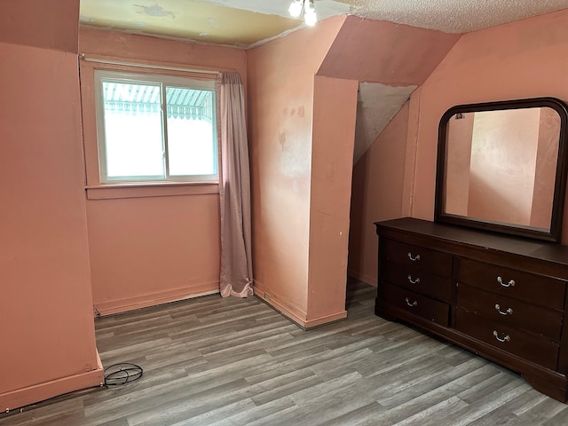 unfurnished bedroom featuring light wood-type flooring and baseboards