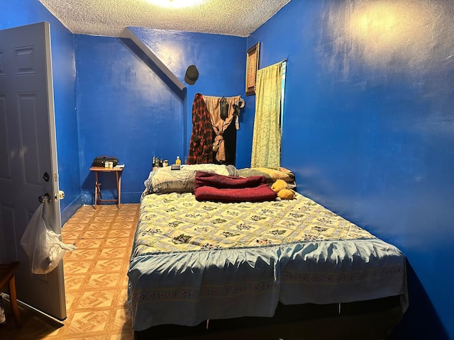 bedroom featuring a textured ceiling