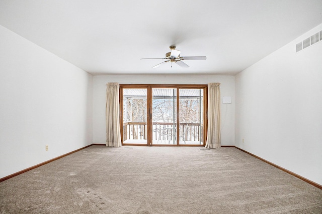 unfurnished room with ceiling fan and carpet