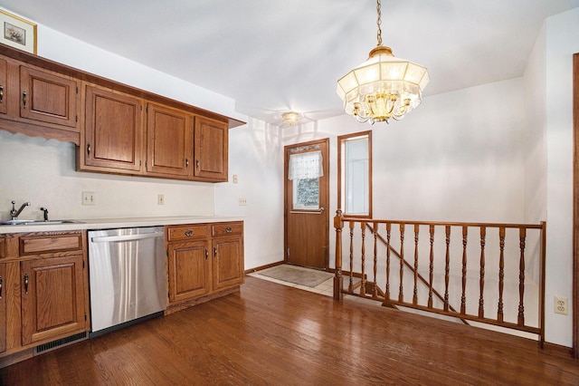 kitchen featuring sink, decorative light fixtures, stainless steel dishwasher, a chandelier, and dark wood-type flooring