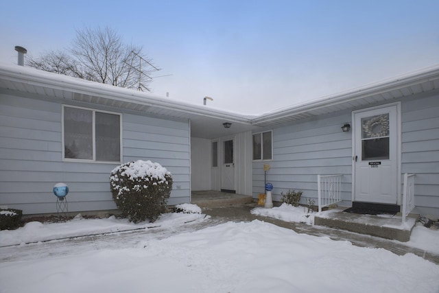 view of snow covered property entrance