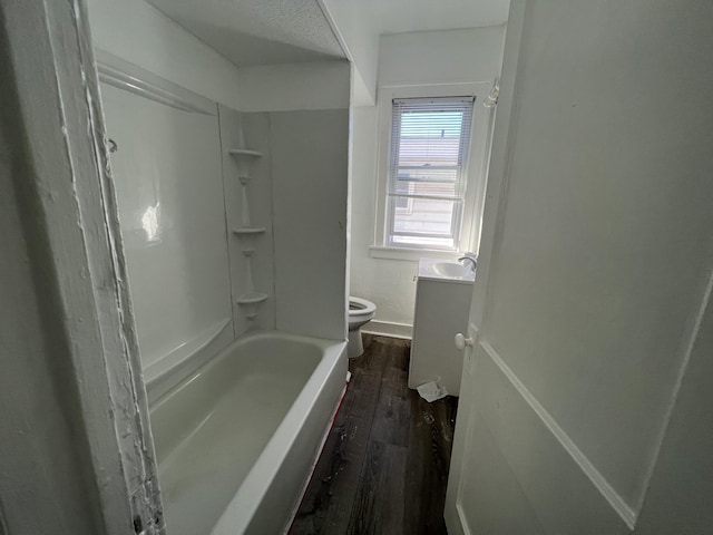 bathroom featuring hardwood / wood-style floors, vanity, toilet, and a textured ceiling