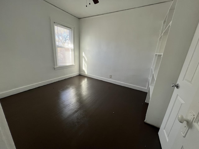 spare room featuring dark hardwood / wood-style floors and ceiling fan