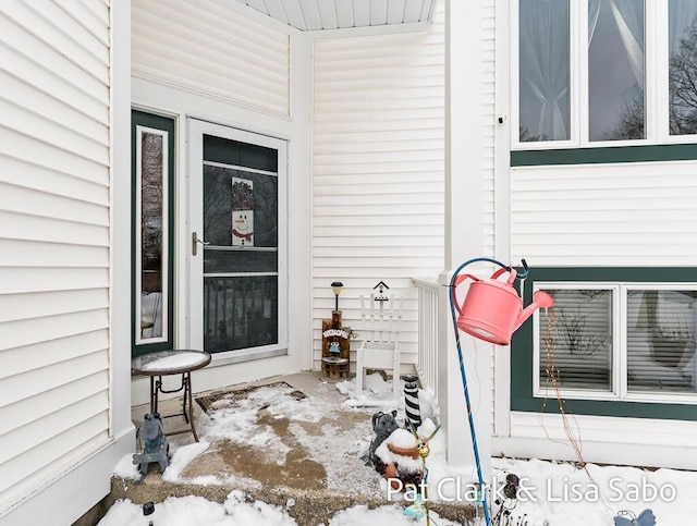 view of snow covered property entrance