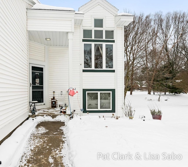 view of snow covered property entrance