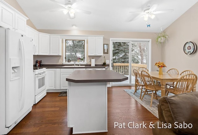 kitchen featuring dark hardwood / wood-style flooring, white appliances, white cabinetry, and ceiling fan