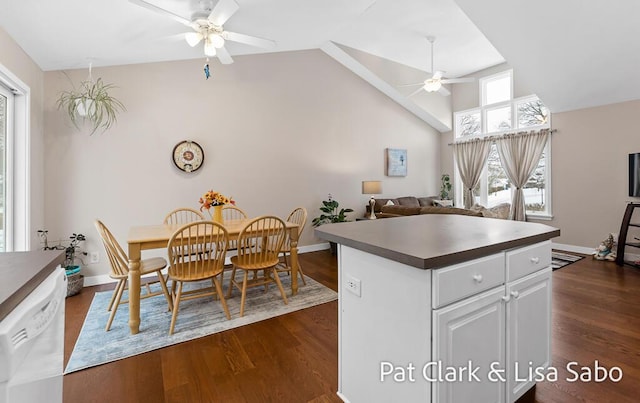 kitchen with white cabinetry, dishwasher, ceiling fan, dark wood-type flooring, and vaulted ceiling