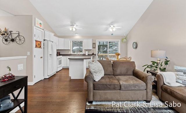 living room with dark hardwood / wood-style flooring, vaulted ceiling, and ceiling fan