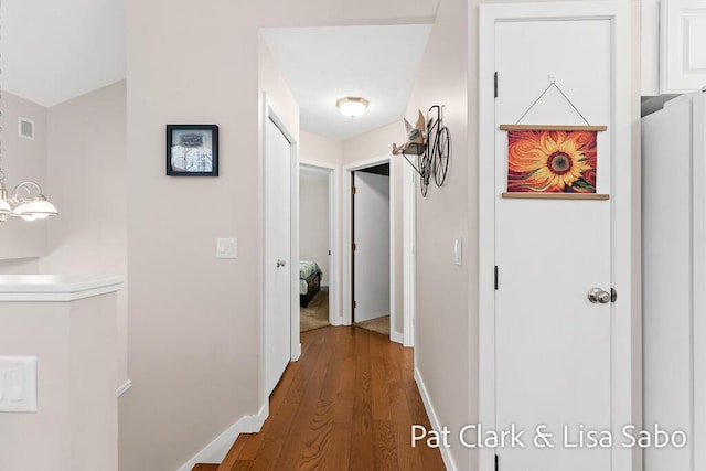 hallway with dark hardwood / wood-style floors