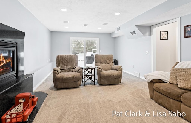 carpeted living room featuring a multi sided fireplace