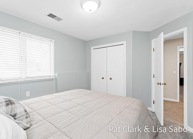 carpeted bedroom featuring a closet