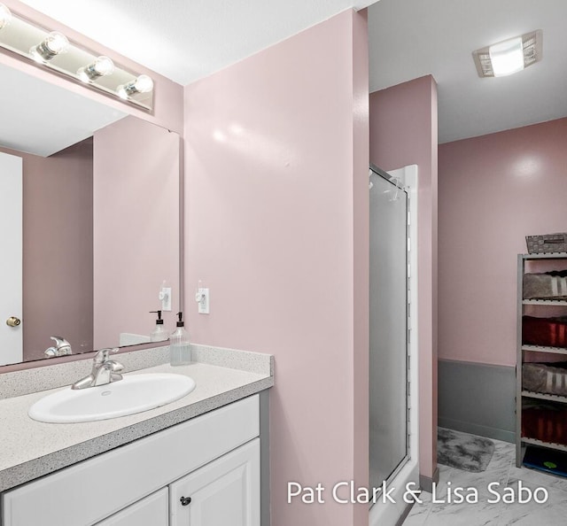 bathroom with vanity and a shower with shower door