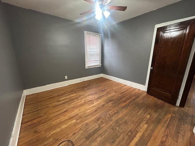13523 Santa Rosa Dr, Detroit, MI 48238 - unfurnished room featuring a ceiling fan, dark wood-style floors, and baseboards