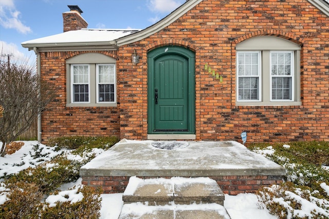 view of snow covered property entrance