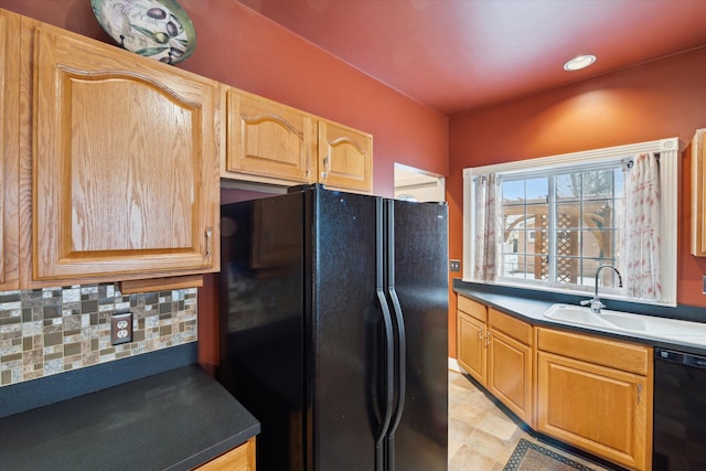 kitchen featuring black appliances, sink, and tasteful backsplash