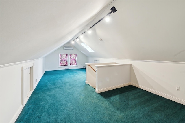 additional living space featuring lofted ceiling, a wall unit AC, and carpet flooring