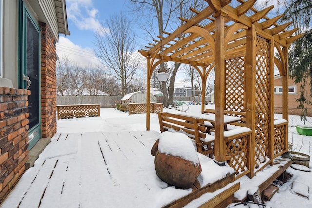 snow covered deck with a pergola