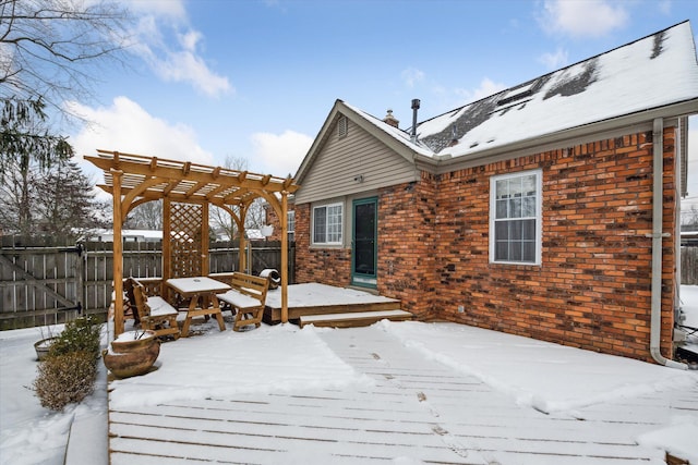 snow covered deck featuring a pergola