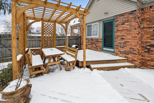 snow covered deck with a pergola