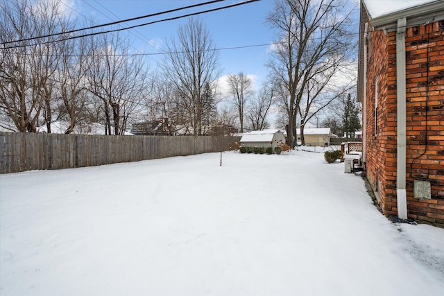 view of yard layered in snow