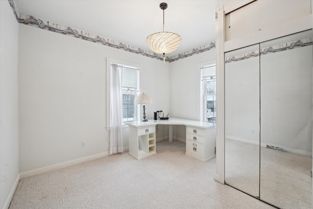 unfurnished office featuring light colored carpet