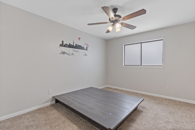 unfurnished bedroom featuring ceiling fan and carpet floors