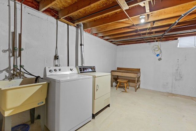 laundry area with washing machine and dryer and sink