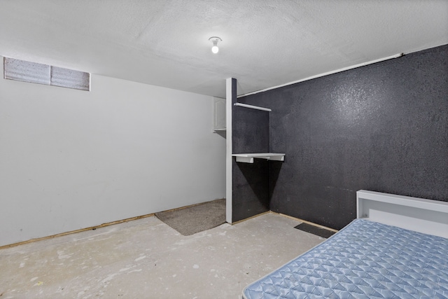 unfurnished bedroom featuring concrete flooring and a textured ceiling