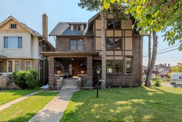 tudor house featuring a front yard