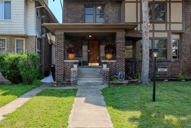 doorway to property featuring a lawn