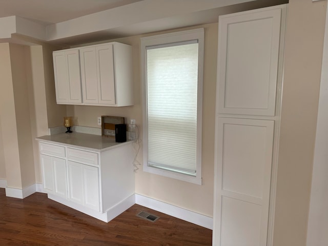 kitchen featuring white cabinetry and dark hardwood / wood-style flooring