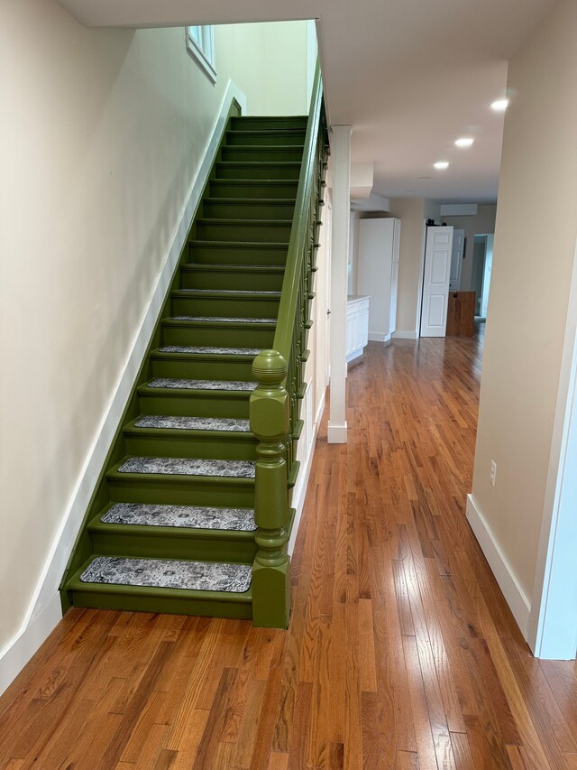 stairway with wood-type flooring