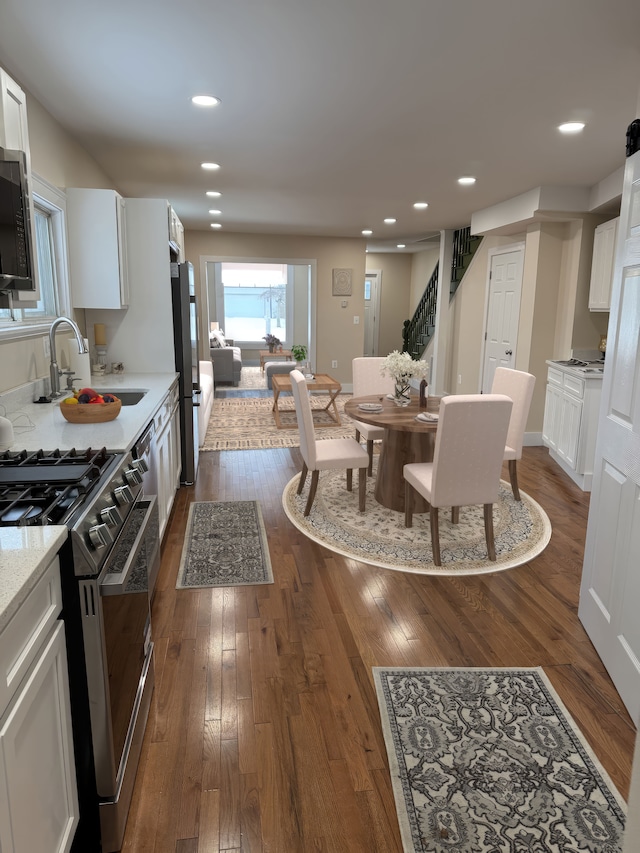 dining area with dark wood-type flooring and sink