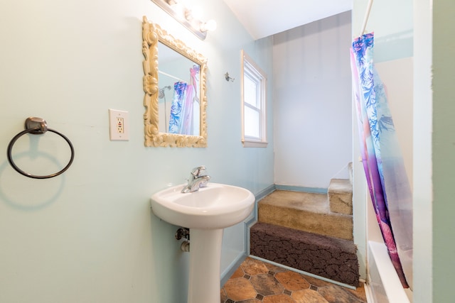 bathroom with sink and shower / bath combination with curtain