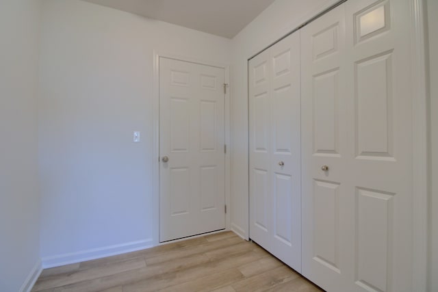 hall with light hardwood / wood-style floors